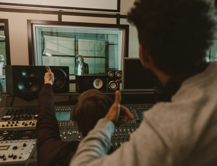 sound producers showing thumbs up to singer at recording studio sound producers showing thumbs up to singer at recording studio
