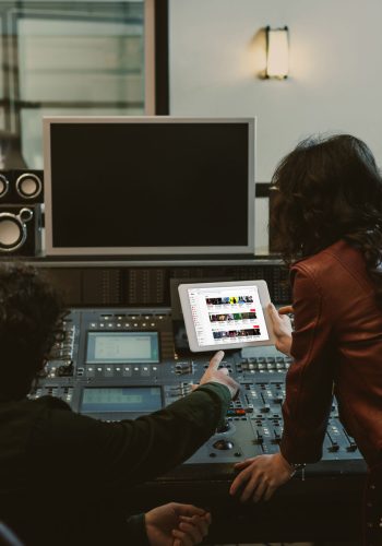 sound producers using tablet together at recording studio with y sound producers using tablet together at recording studio with youtube website on screen
